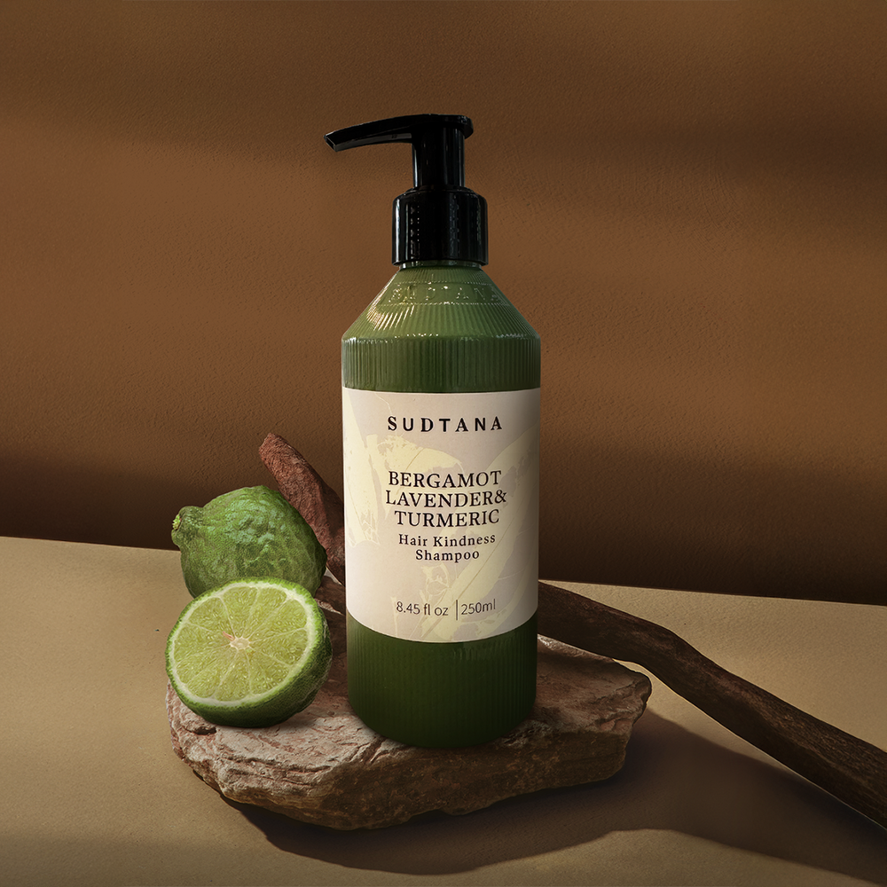 A bottle of SUDTANA’s Bergamot Lavender & Turmeric Hair Kindness Shampoo: a natural Thai herbal, sulphate-free, spa-grade formula for dry, frizzy, colour-treated hair.