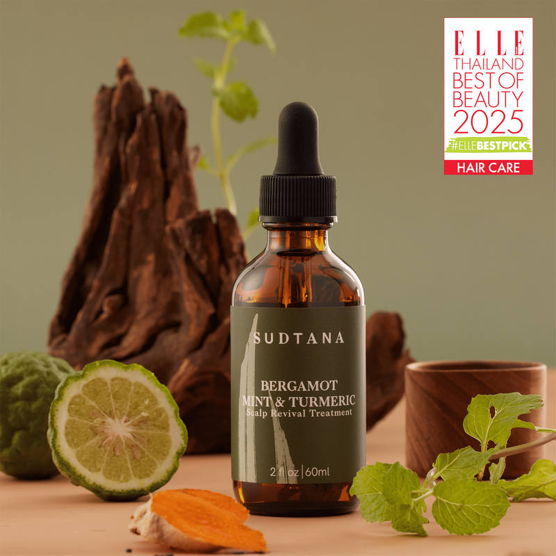 A bottle of the award-winning SUDTANA Bergamot Mint & Turmeric Scalp Revival Treatment, an all-natural dry scalp treatment designed to nourish and strengthen your hair from roots to ends.